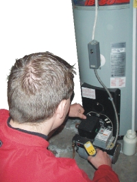 Mark Hendley inspecting a water heater